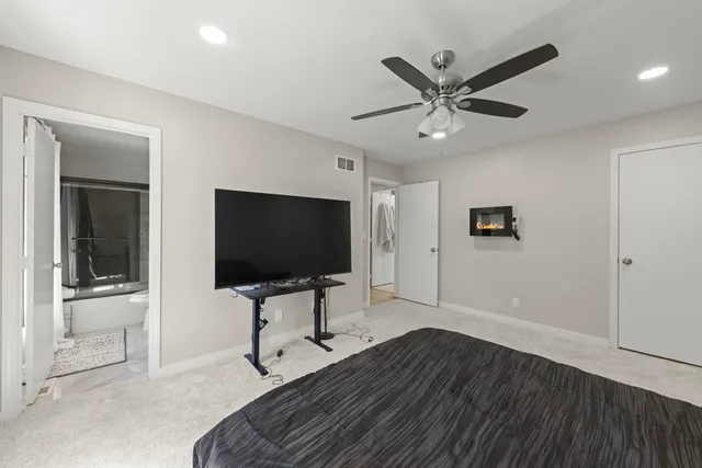 a work room with wooden floor and ceiling fan