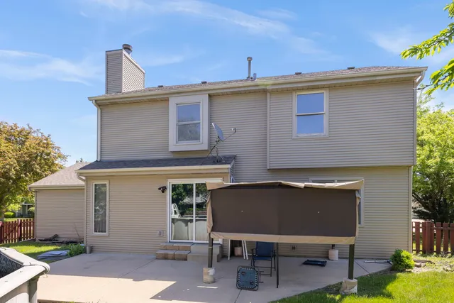 a view of a terrace with chairs and potted plants