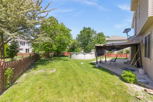 a view of a yard with furniture and a small cabin