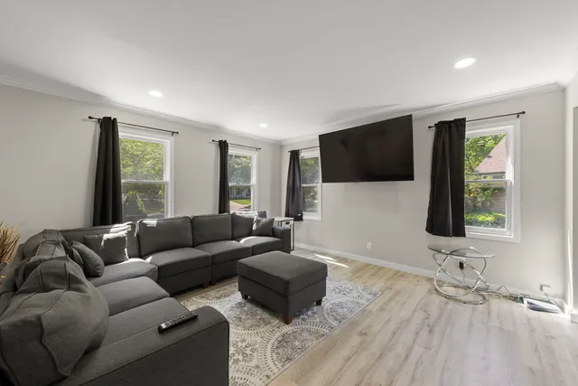 a living room with furniture and a flat screen tv