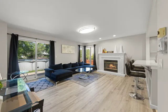 a living room with furniture fireplace and window
