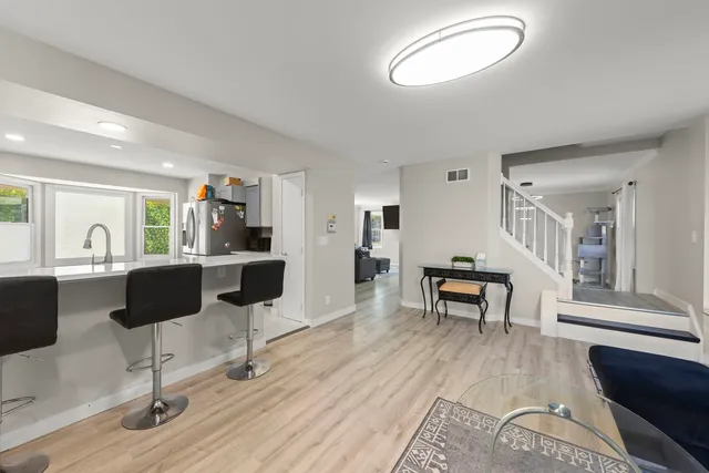 a living room with furniture or couch and a wooden floor