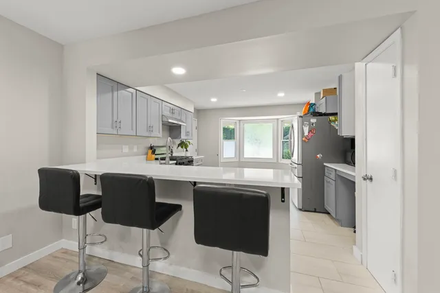 a kitchen with a sink cabinets and window