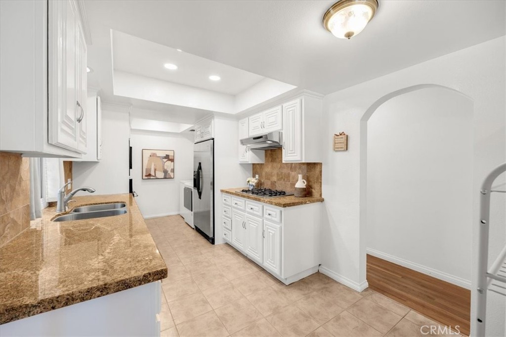 2956 Monogram Avenue Long Beach, CA 90815 - Photo 11 of 29 a kitchen with stainless steel appliances granite countertop a sink stove and refrigerator