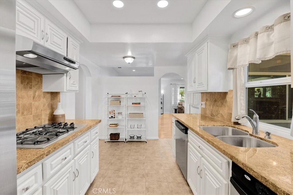 2956 Monogram Avenue Long Beach, CA 90815 - Photo 12 of 29 a kitchen with granite countertop a sink stove and cabinets