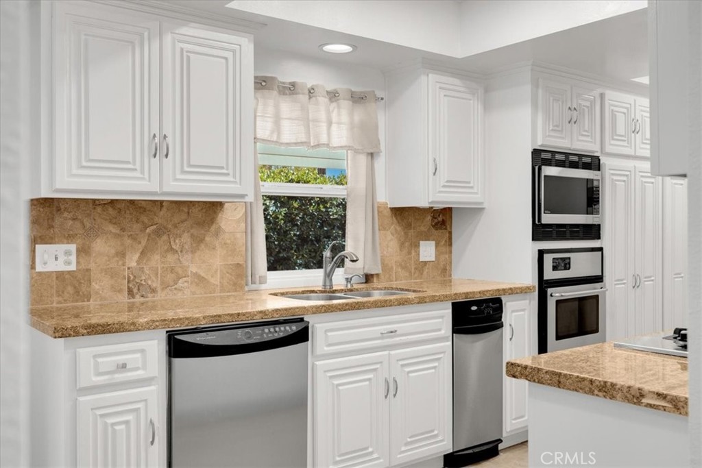 2956 Monogram Avenue Long Beach, CA 90815 - Photo 14 of 29 a kitchen with stainless steel appliances granite countertop a sink and a stove