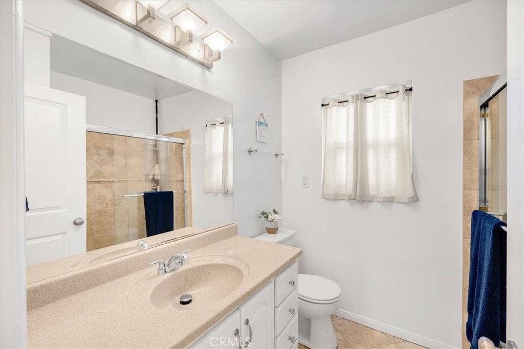 2956 Monogram Avenue Long Beach, CA 90815 - Photo 16 of 29 a bathroom with a sink a toilet a mirror and shower