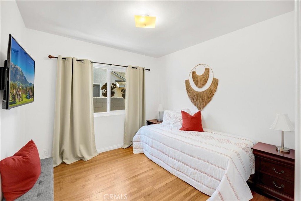 2956 Monogram Avenue Long Beach, CA 90815 - Photo 17 of 29 a bedroom with a bed and a lamp on table