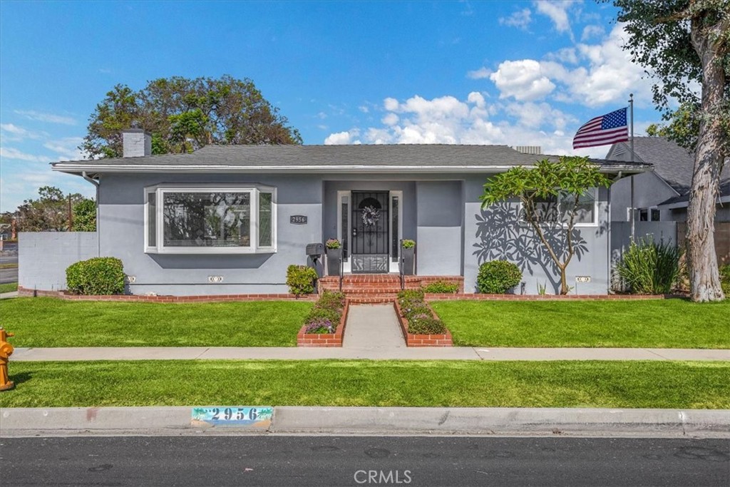 2956 Monogram Avenue Long Beach, CA 90815 - Photo 2 of 29 a front view of a house with a yard and potted plants