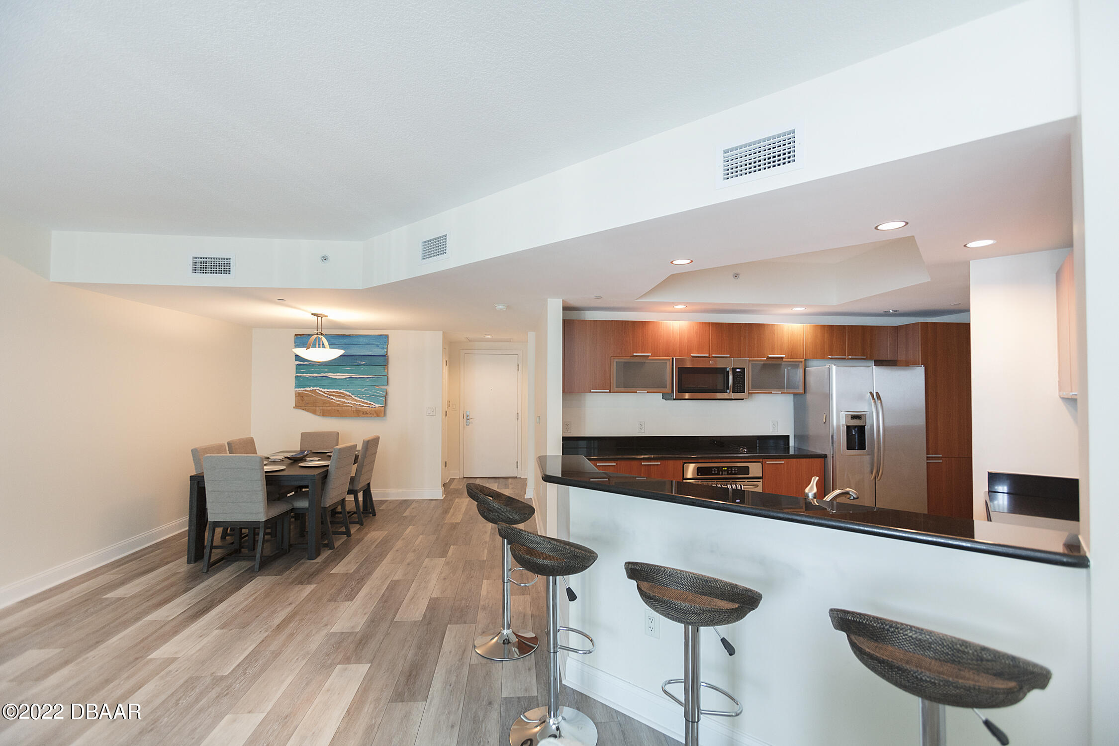231 Riverside Drive, Unit 11061 Holly Hill, FL 32117 - Photo 16 of 64 a kitchen with stainless steel appliances kitchen island granite countertop a sink and a refrigerator