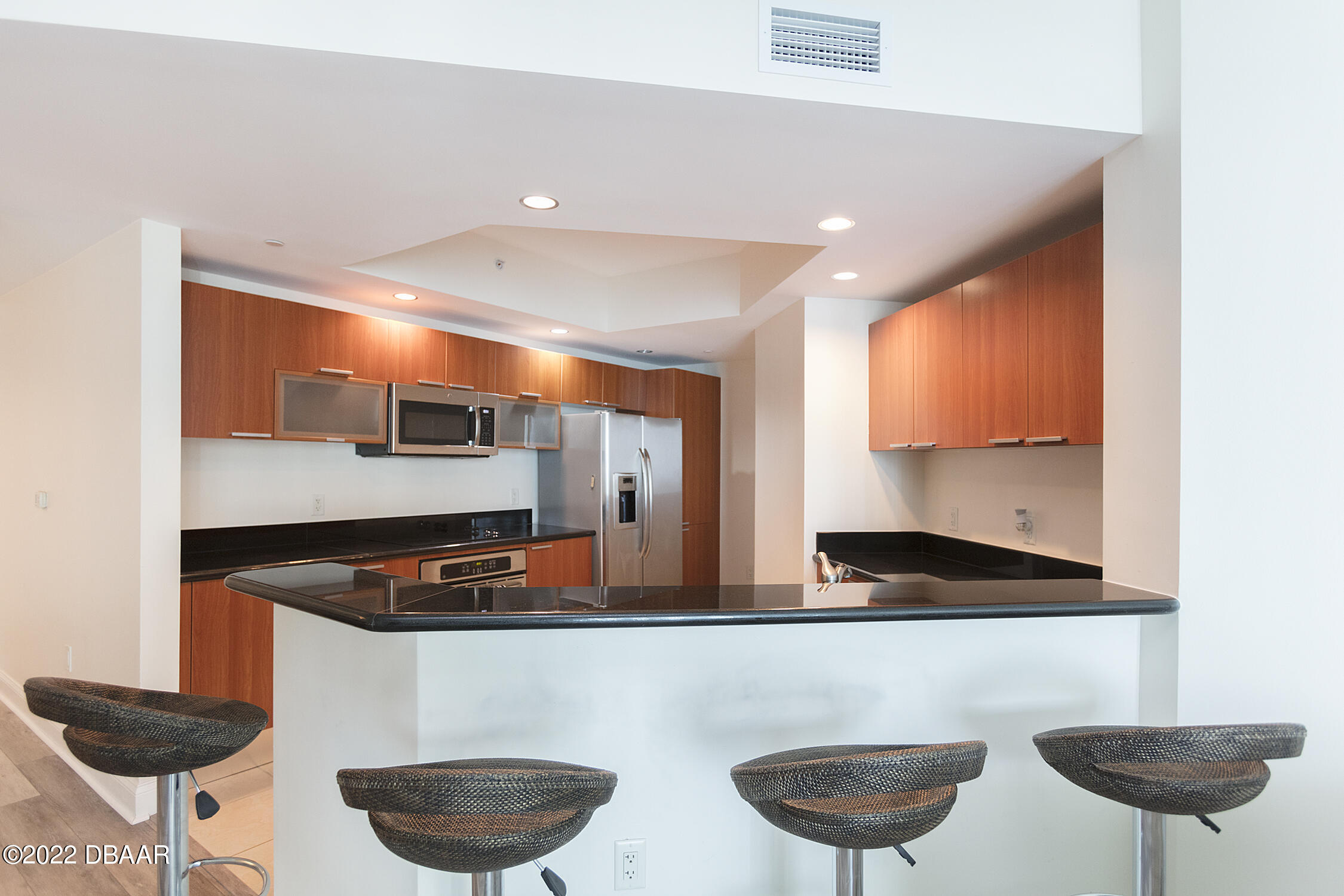 231 Riverside Drive, Unit 11061 Holly Hill, FL 32117 - Photo 17 of 64 a kitchen with a dining table and chairs