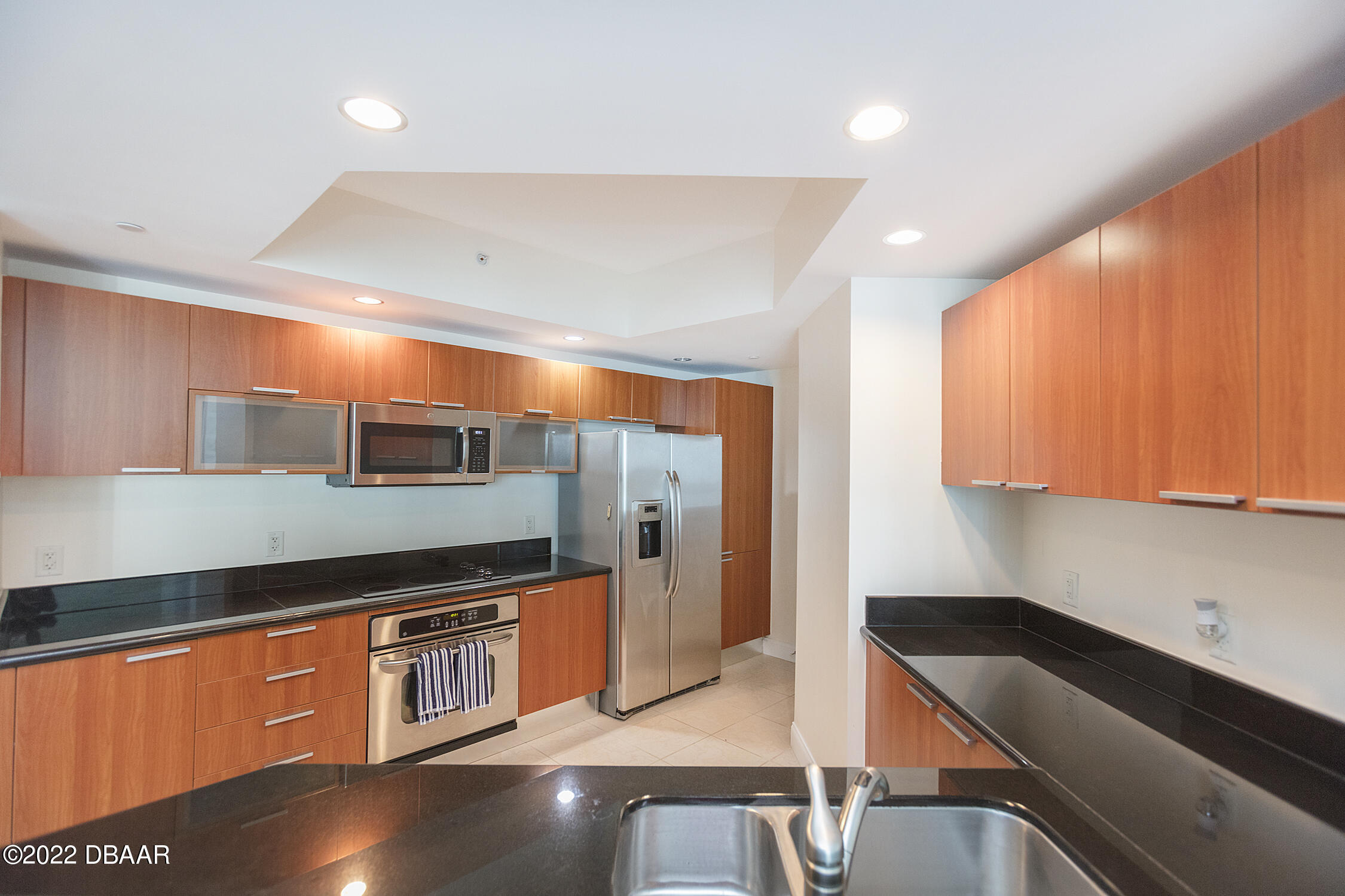 231 Riverside Drive, Unit 11061 Holly Hill, FL 32117 - Photo 18 of 64 a kitchen with stainless steel appliances a sink stove and cabinets