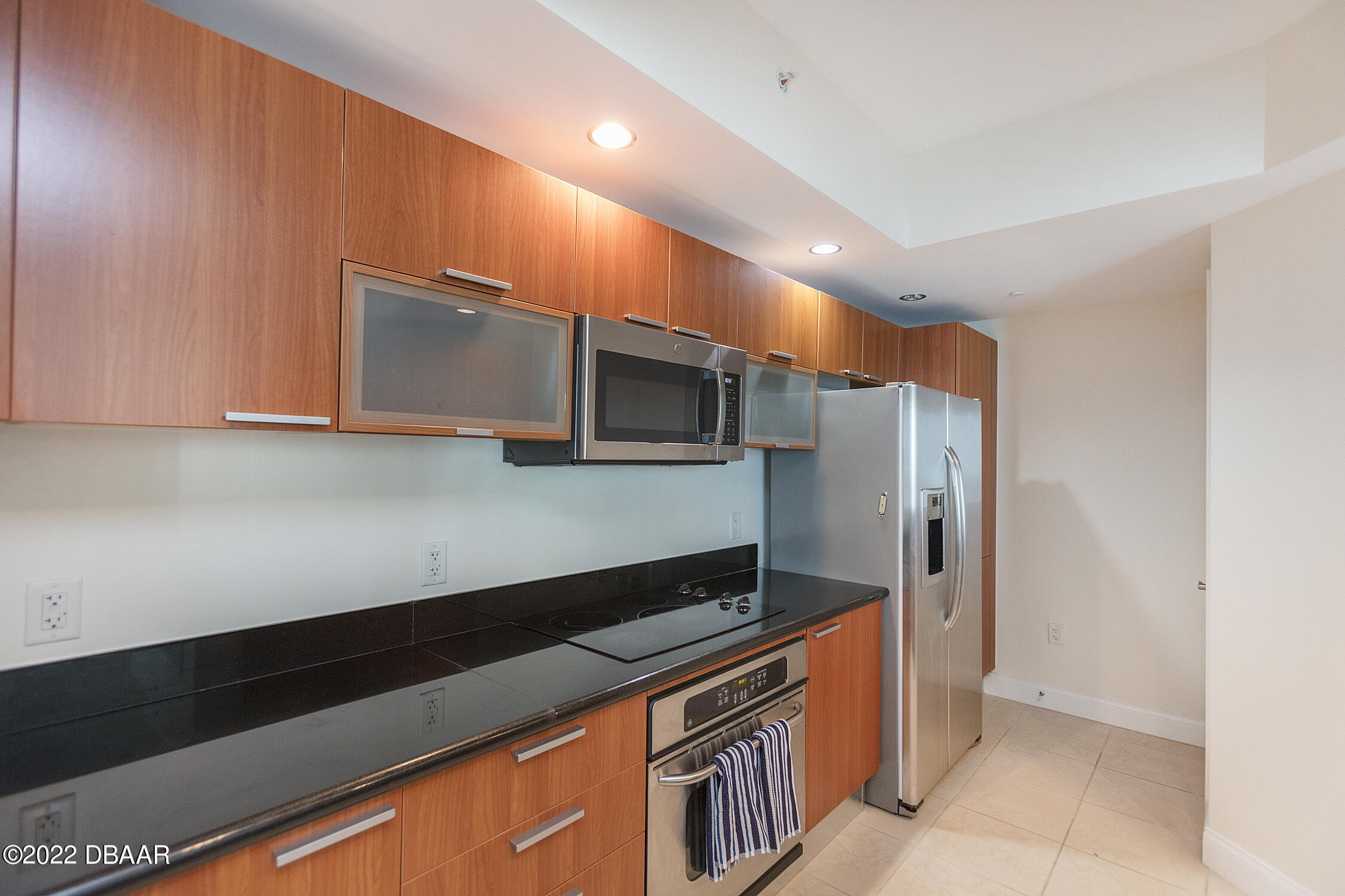 231 Riverside Drive, Unit 11061 Holly Hill, FL 32117 - Photo 20 of 64 a kitchen with stainless steel appliances a sink and a microwave