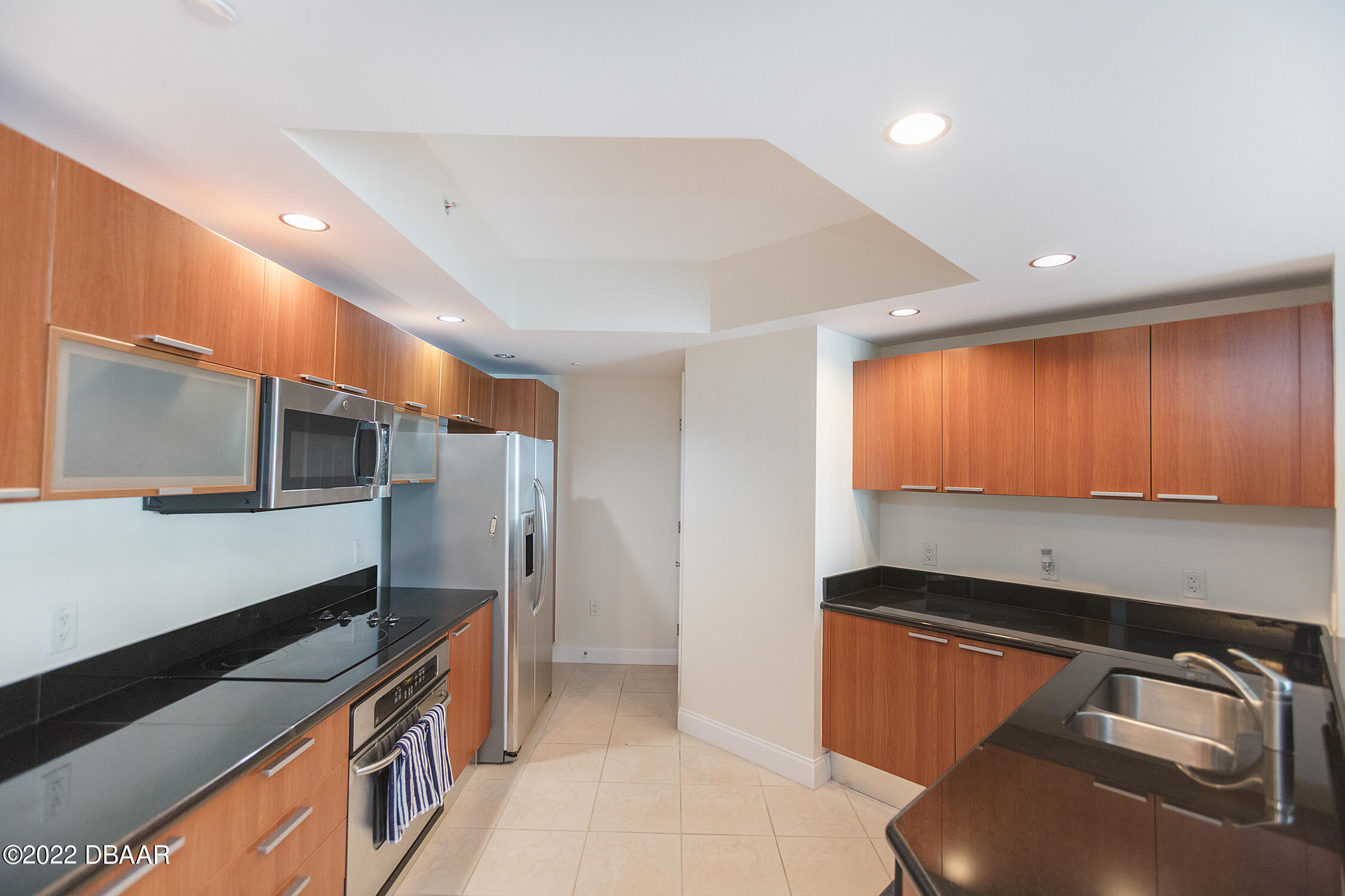 231 Riverside Drive, Unit 11061 Holly Hill, FL 32117 - Photo 21 of 64 a kitchen with stainless steel appliances granite countertop a sink and a stove top oven