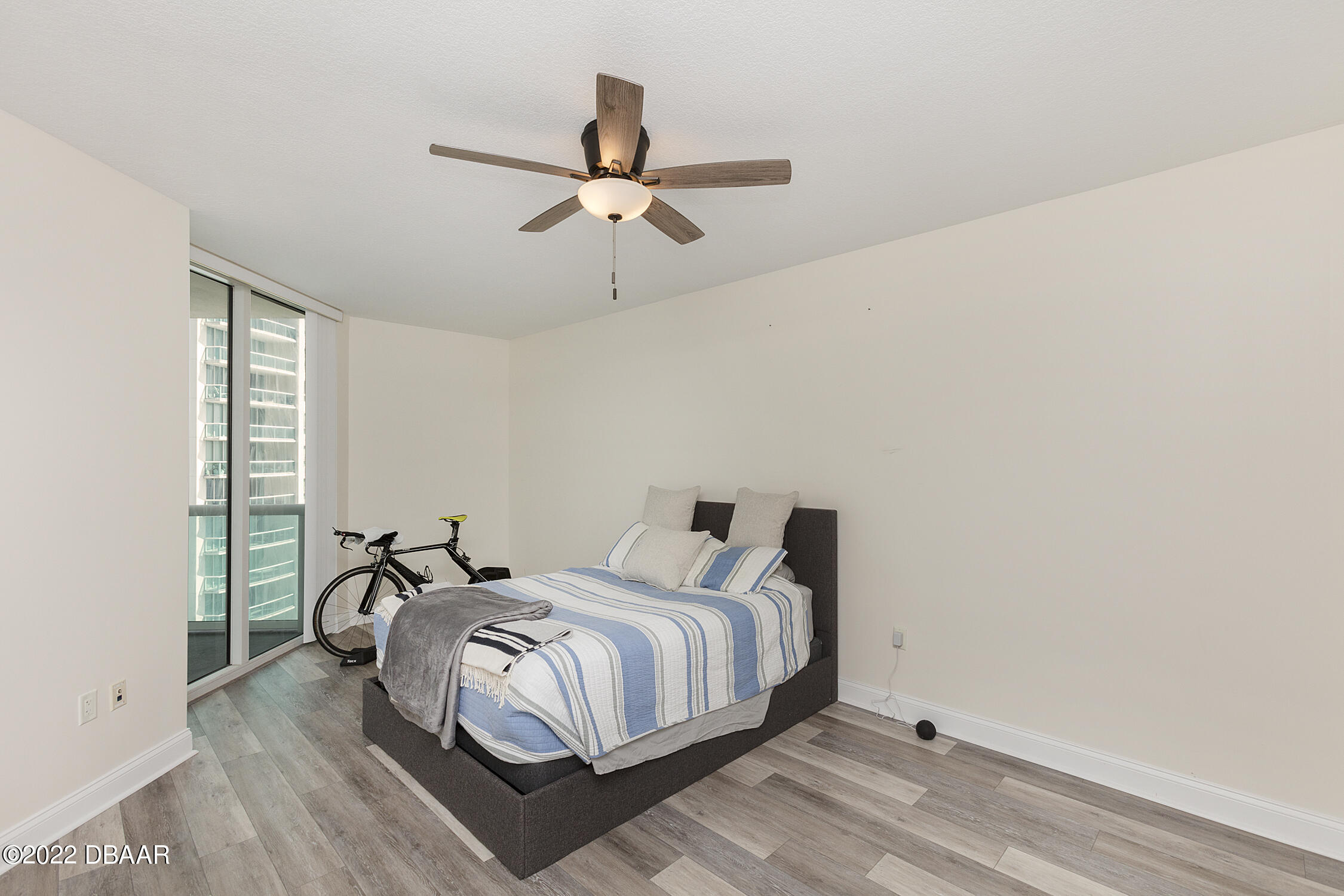 231 Riverside Drive, Unit 11061 Holly Hill, FL 32117 - Photo 22 of 64 a bedroom with a bed and wooden floor