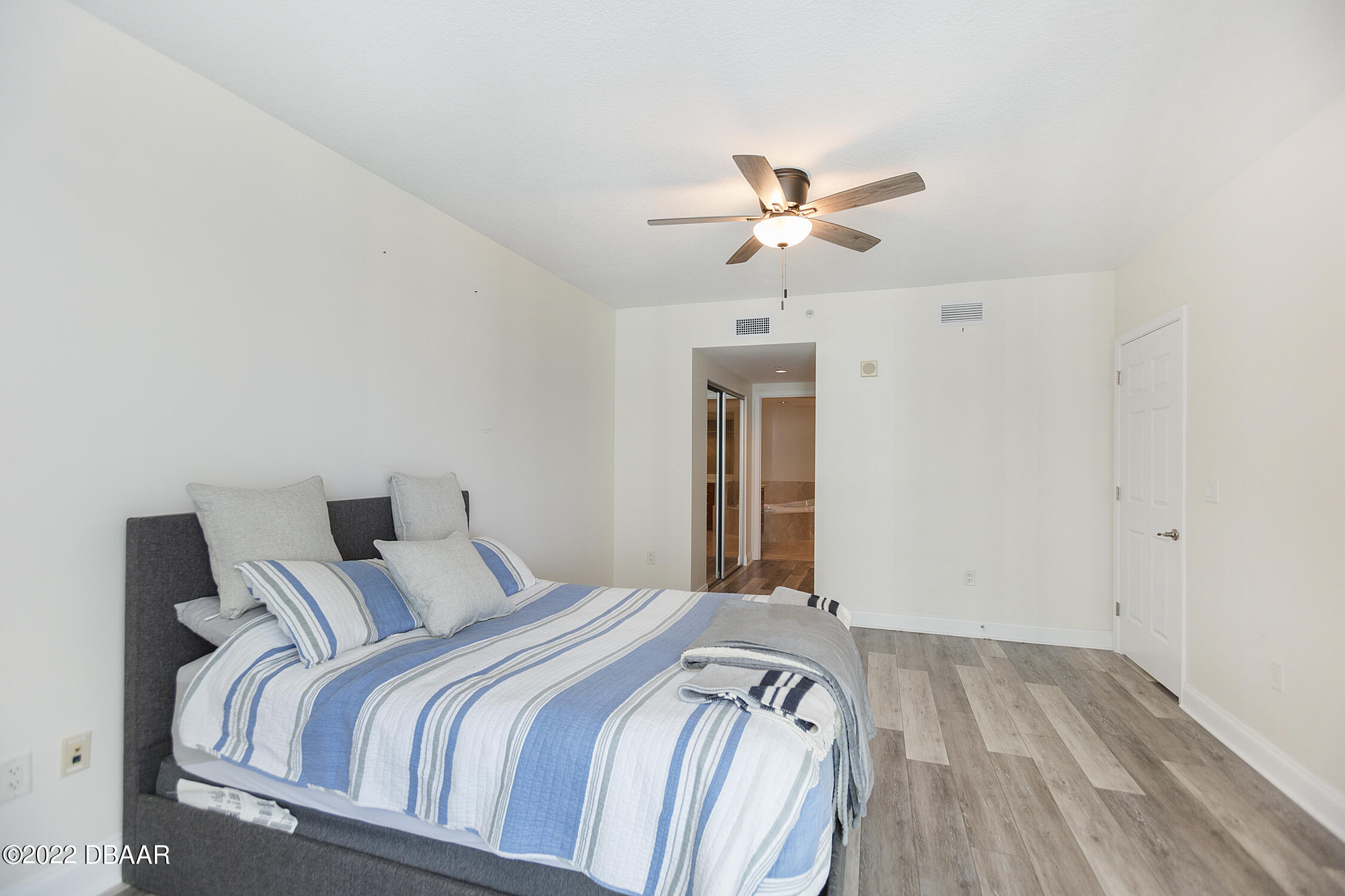 231 Riverside Drive, Unit 11061 Holly Hill, FL 32117 - Photo 25 of 64 a bedroom with a bed and ceiling fan