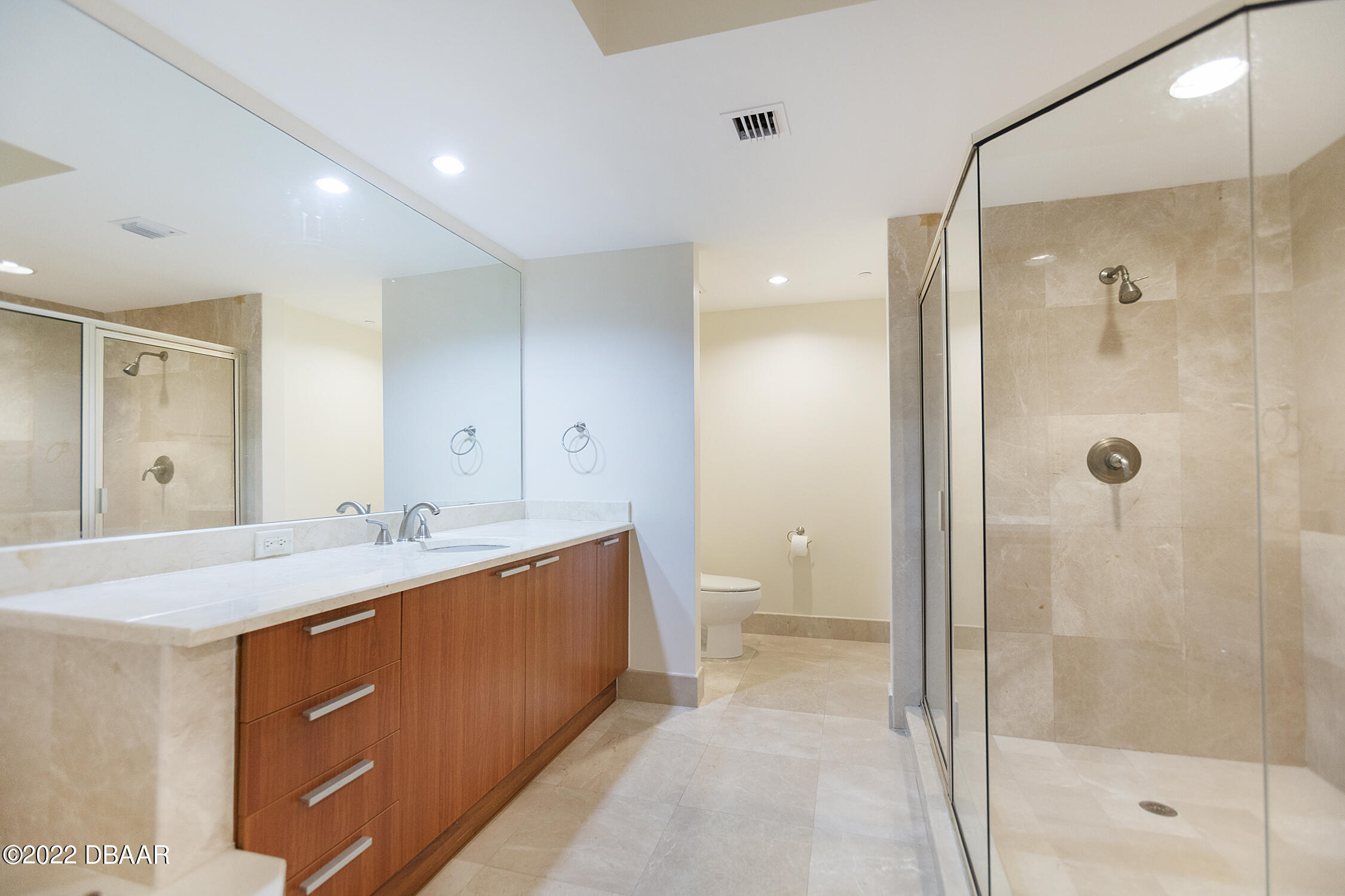 231 Riverside Drive, Unit 11061 Holly Hill, FL 32117 - Photo 28 of 64 a bathroom with a double vanity sink mirror double and shower