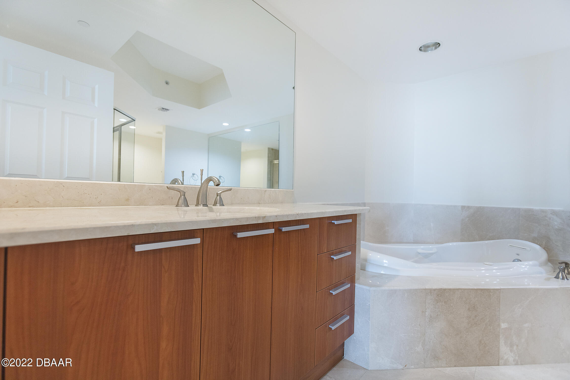 231 Riverside Drive, Unit 11061 Holly Hill, FL 32117 - Photo 29 of 64 a bathroom with a sink a mirror and a bathtub