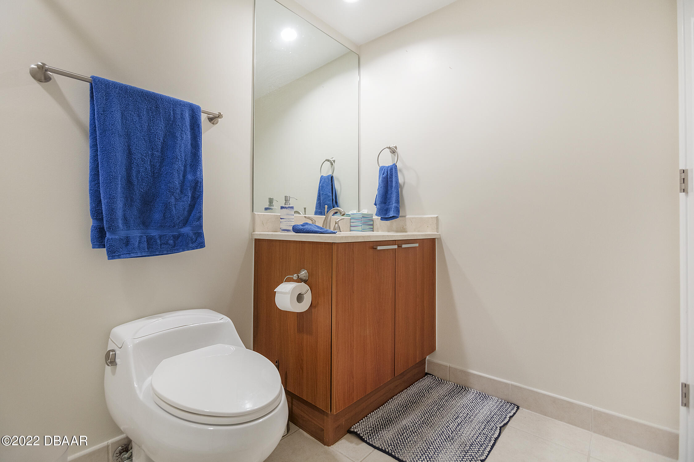231 Riverside Drive, Unit 11061 Holly Hill, FL 32117 - Photo 38 of 64 a bathroom with a toilet a sink and mirror