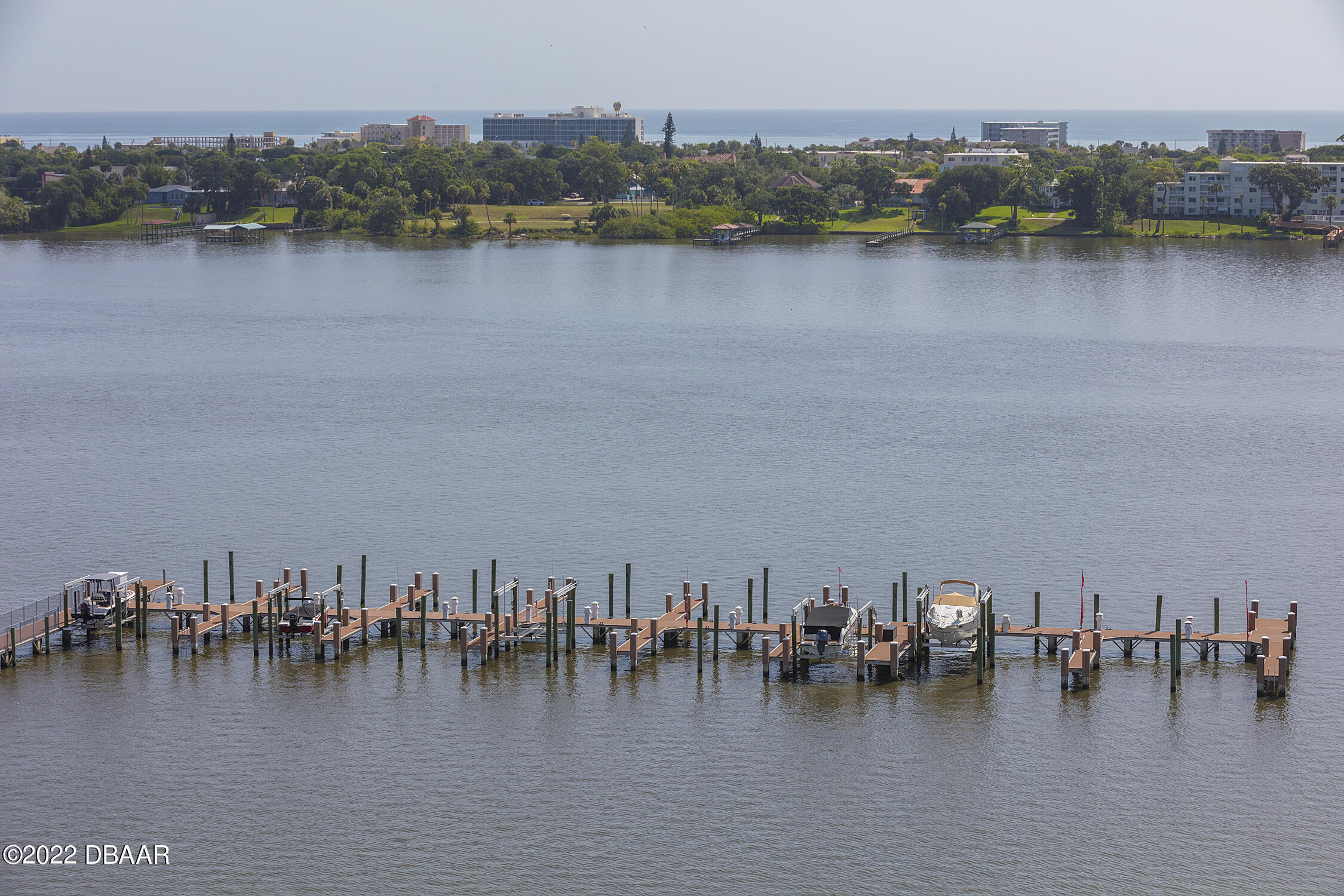 231 Riverside Drive, Unit 11061 Holly Hill, FL 32117 - Photo 43 of 64 a view of an ocean with boats and trees in the back