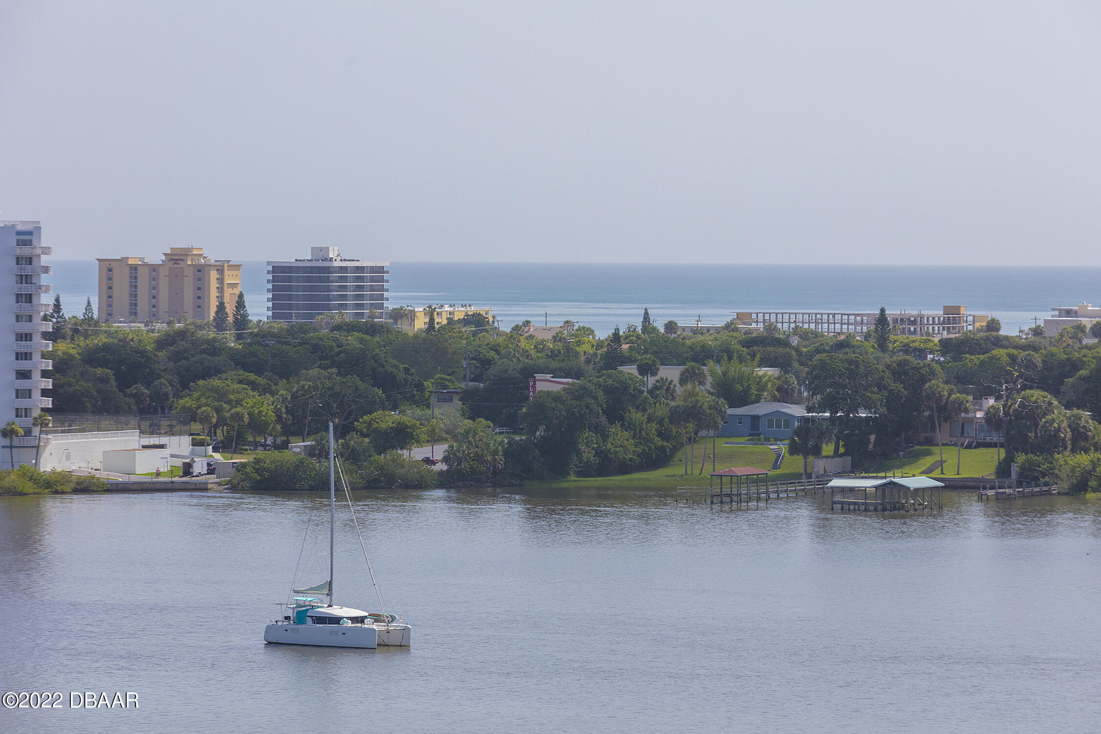 231 Riverside Drive, Unit 11061 Holly Hill, FL 32117 - Photo 5 of 64 a view of a lake with tall buildings