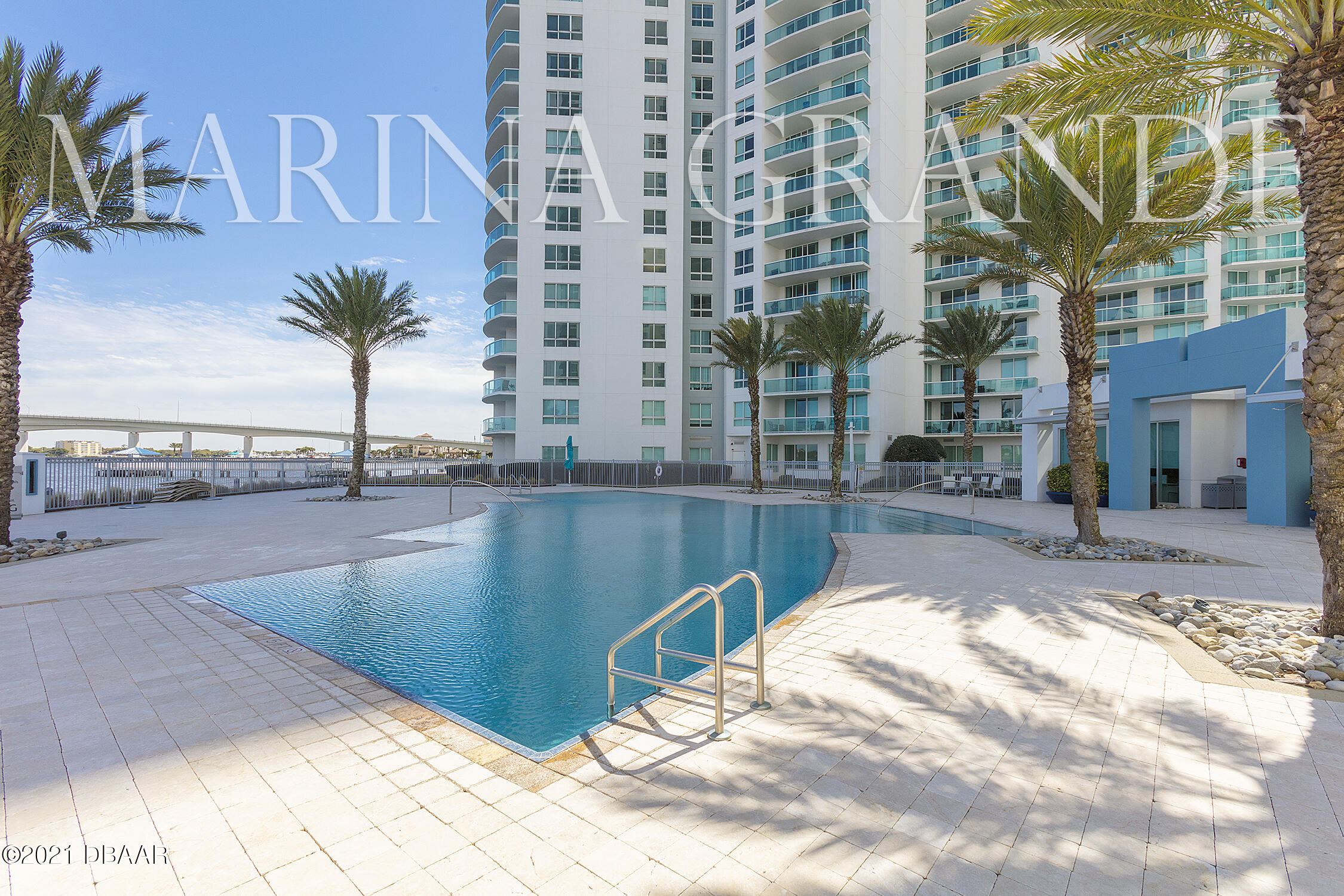 231 Riverside Drive, Unit 11061 Holly Hill, FL 32117 - Photo 56 of 64 a view of a swimming pool with a lounge chairs