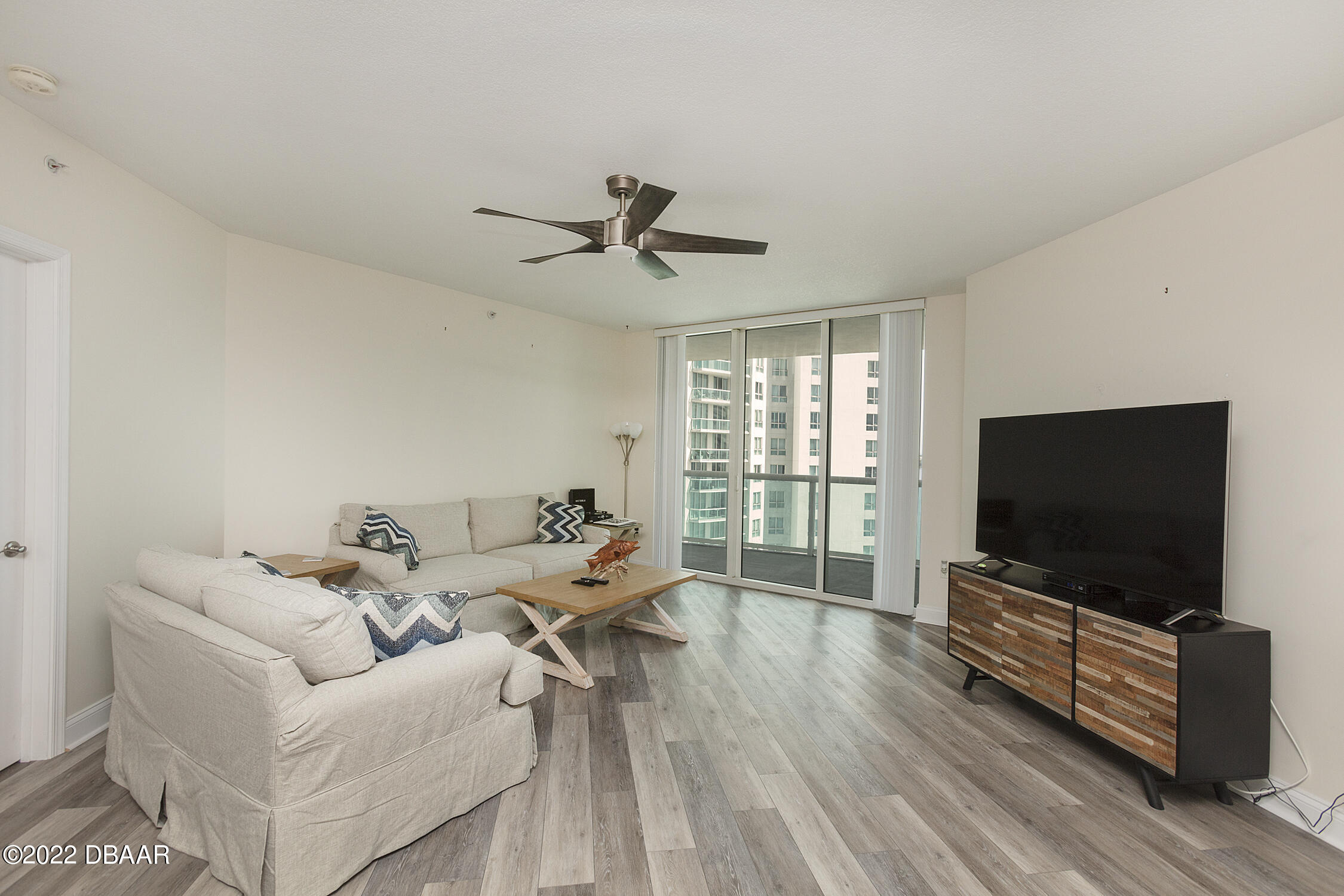 231 Riverside Drive, Unit 11061 Holly Hill, FL 32117 - Photo 9 of 64 a living room with furniture and a flat screen tv