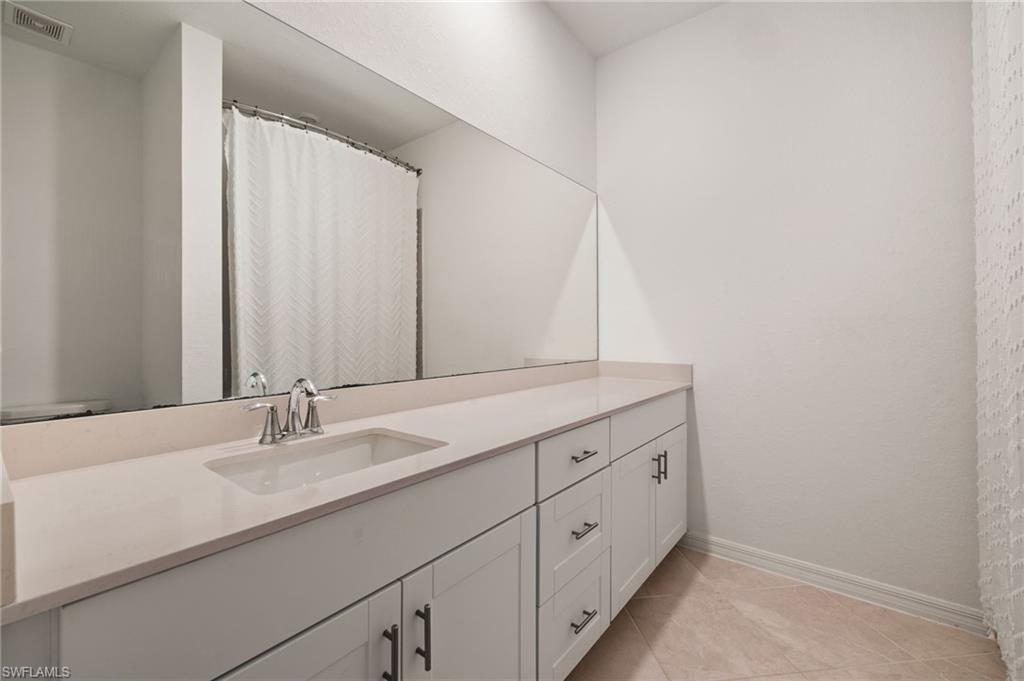 2934 Citrus Street Naples, FL 34120 - Photo 17 of 29 a bathroom with a sink and a mirror
