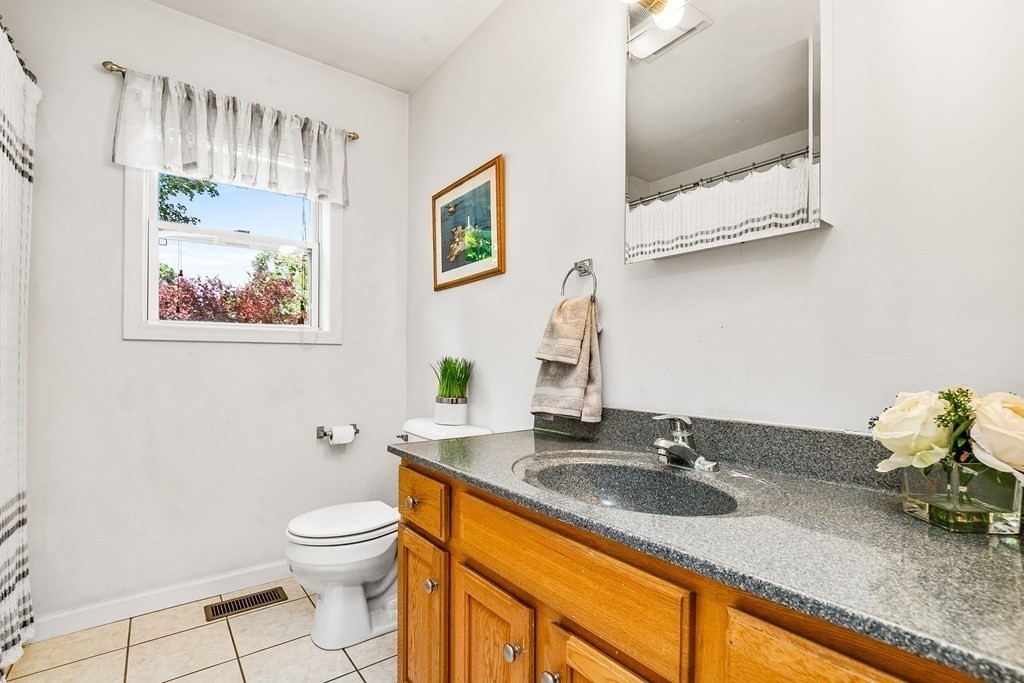 111 Wompatuck Road Hingham, MA 02043 - Photo 12 of 33 a bathroom with a granite countertop sink mirror and toilet