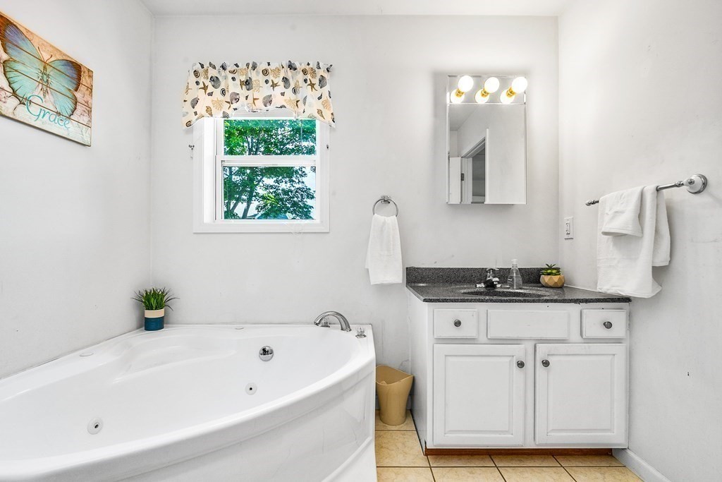 111 Wompatuck Road Hingham, MA 02043 - Photo 15 of 33 a bathroom with a granite countertop tub sink and window