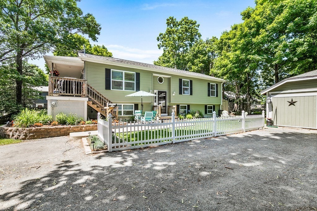 111 Wompatuck Road Hingham, MA 02043 - Photo 23 of 33 a front view of a house with a garden and deck