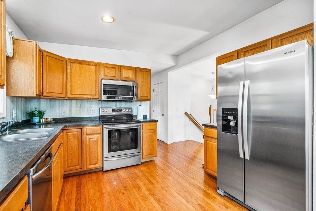 111 Wompatuck Road Hingham, MA 02043 - Photo 10 of 33 a kitchen with stainless steel appliances granite countertop a stove a sink and a refrigerator