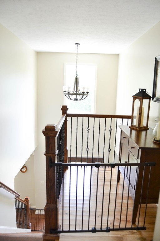 89 Davis Road Westminster, MA 01473 - Photo 13 of 25 a view of staircase with railing and a chandelier