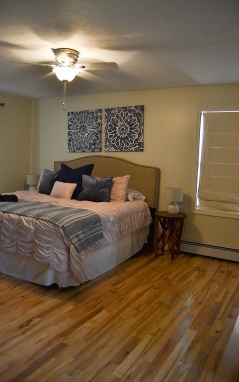 89 Davis Road Westminster, MA 01473 - Photo 14 of 25 a bedroom with a bed and a chandelier