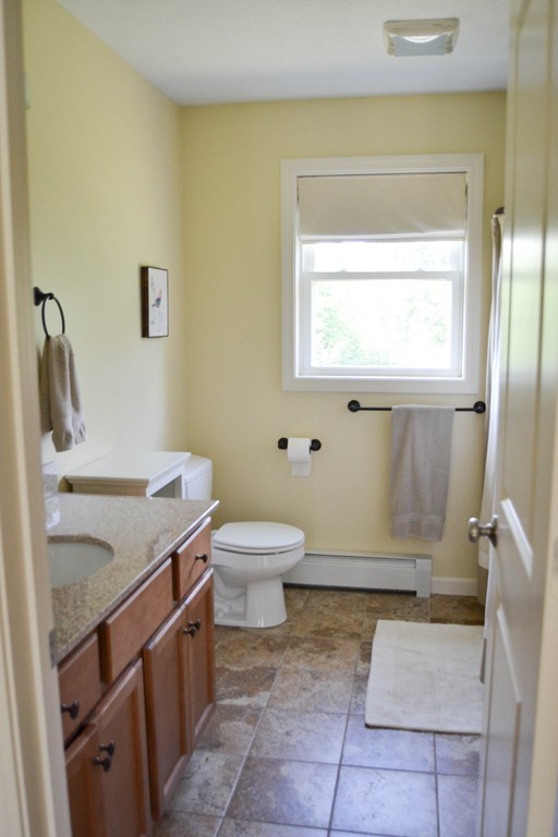 89 Davis Road Westminster, MA 01473 - Photo 16 of 25 a bathroom with a granite countertop sink a toilet and a mirror