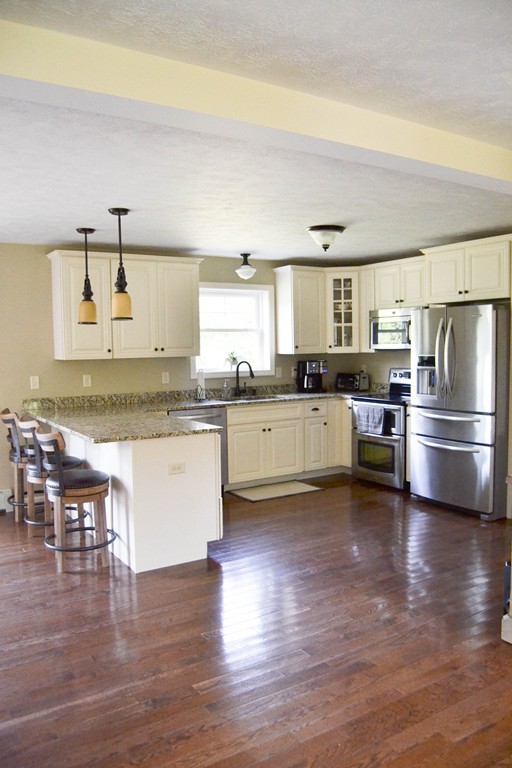 89 Davis Road Westminster, MA 01473 - Photo 5 of 25 a kitchen with stainless steel appliances granite countertop a stove a sink and a refrigerator