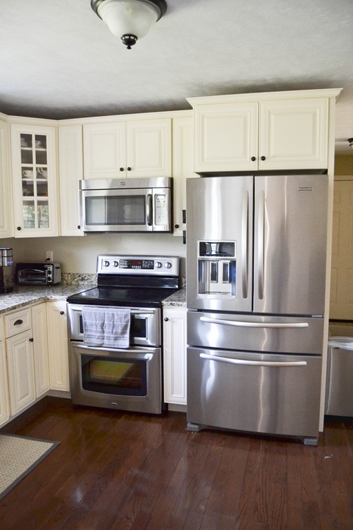89 Davis Road Westminster, MA 01473 - Photo 7 of 25 a kitchen with refrigerator a stove and a window