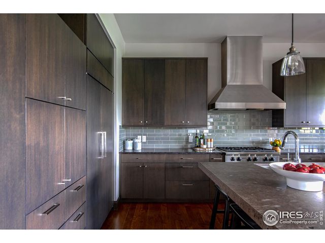 a kitchen with kitchen island granite countertop a sink stainless steel appliances and cabinets