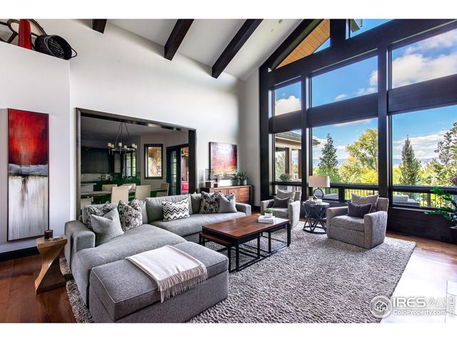 a living room with furniture and floor to ceiling window