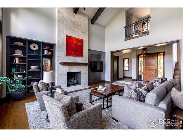 a living room with furniture a bookshelf and a fireplace