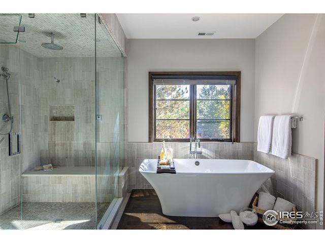 a bathroom with a tub a sink and a shower