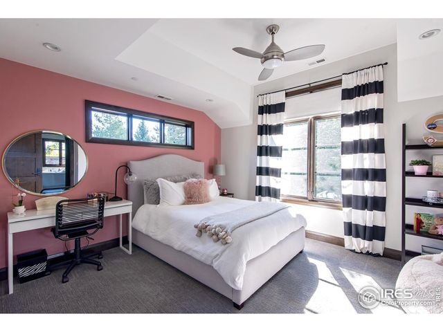 a bedroom with a bed a bookshelf and a book shelf