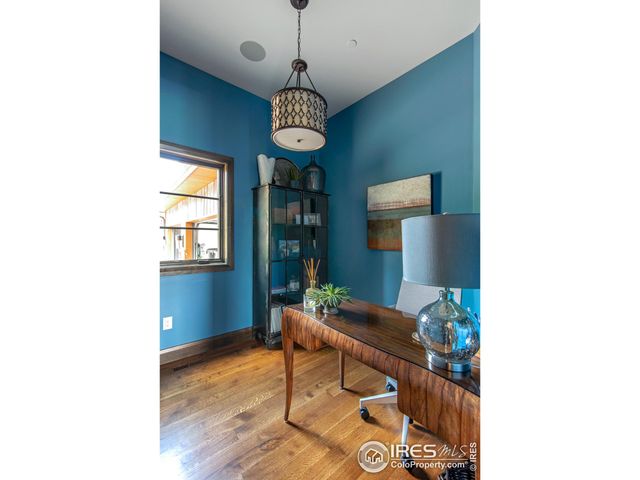 a view of a dining room with a table and chairs