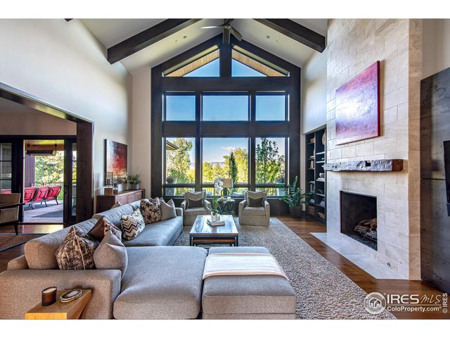 a living room with furniture fireplace and a large window