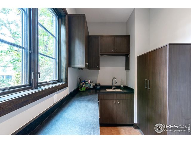 a kitchen with a refrigerator and a sink