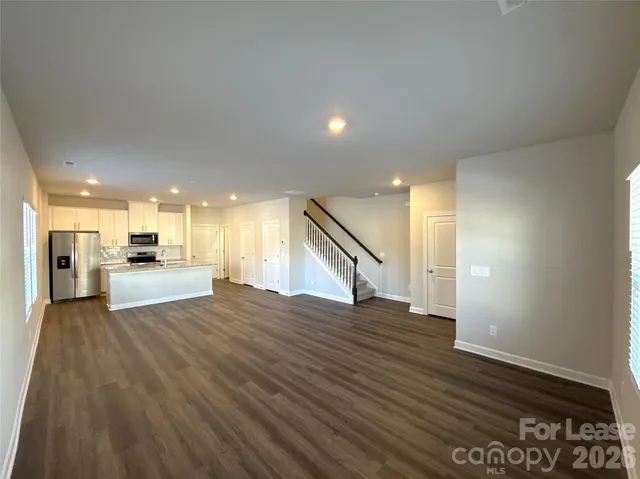 a view of kitchen with furniture and wooden floor