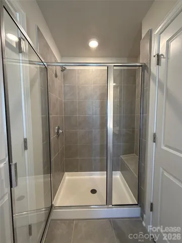 a bathroom with a shower and a sink