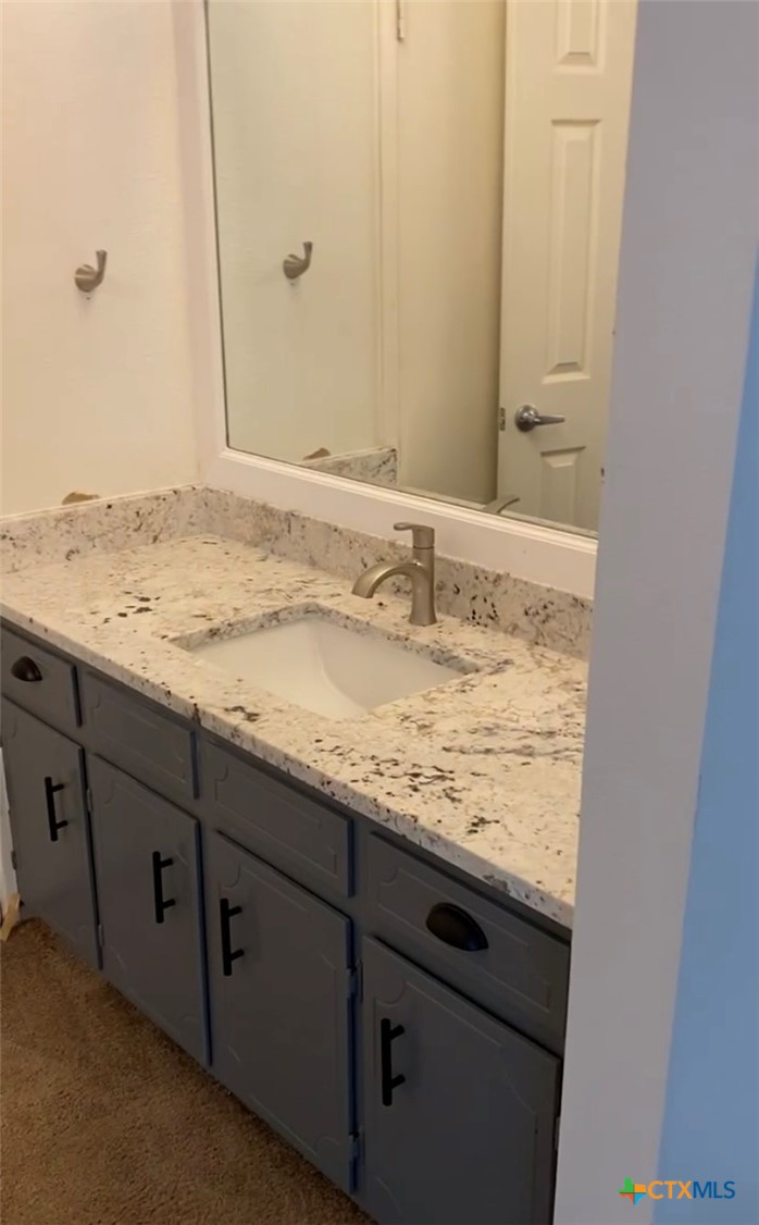 1316 Opal Road, Unit A Killeen, TX 76543 - Photo 20 of 25 a bathroom with a granite countertop sink and a mirror