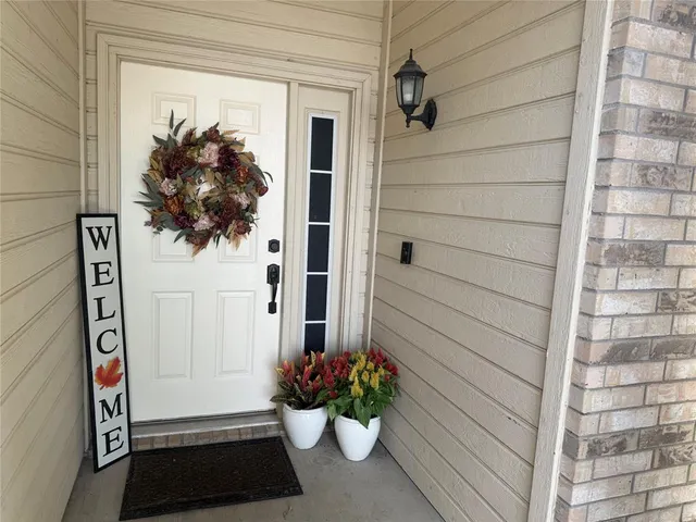 a vase of flowers sitting on a floor