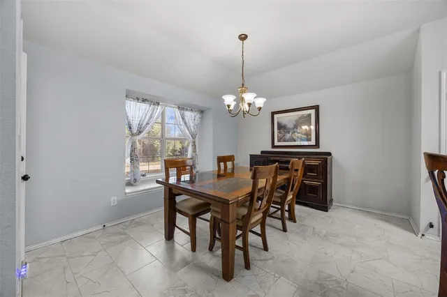 a view of a dining room with furniture window and chandelier